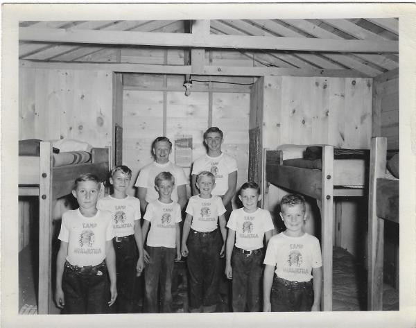 historic photo of boys standing in a bunk room